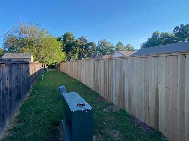 Cap and trim cedar privacy fence installation